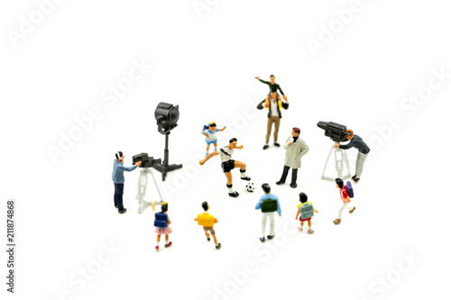 Miniature people   Cameramen  photographers and reporters interviewing football player with children student.