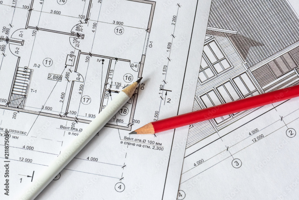 The architectural plan of the house is printed on a white sheet of paper. A red and white pencil on it. June 2018, Russia, Moscow The architectural plan of the house is printed on a white sheet of paper. A red and white pencil on it. June 2018, Russia, Moscow