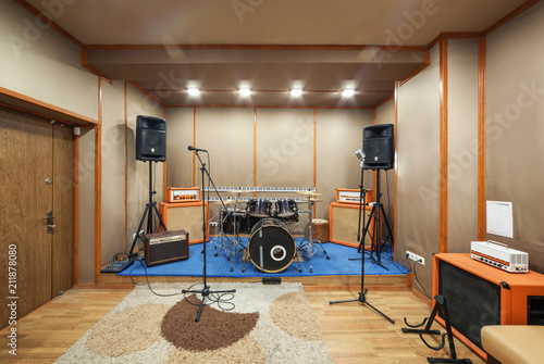 Sound studio room with drum kit.