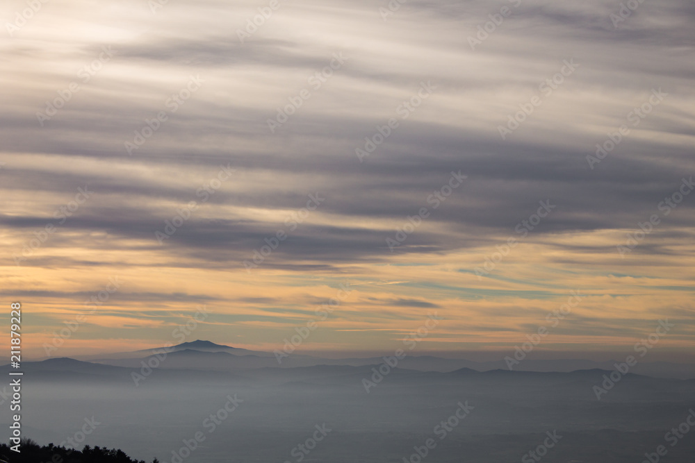 Subasio Mt. (Umbria, Italy), with sky covered by clouds and warm sunset colors