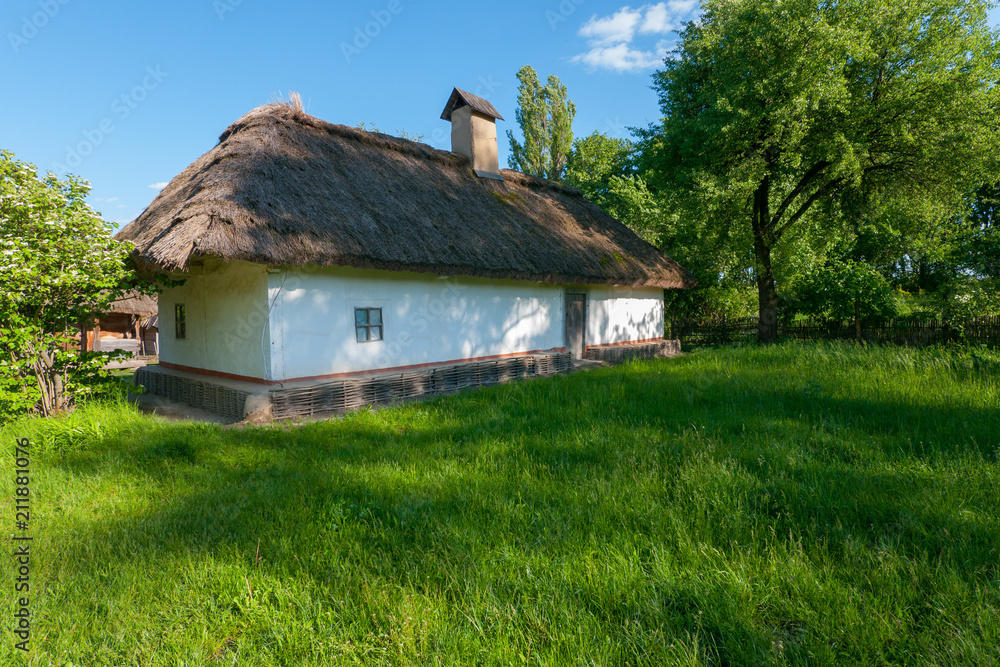 Fototapeta premium An old hut of Smoker Cretaceous with a reed and with an unbreakable foundation in the museum under the loose sky. Uzhhorod Ukraine
