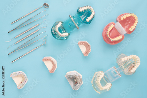 dentist tools and orthodontic on the blue background, flat lay, top vipw.