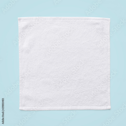 White cotton towel mock up template square size fabric wiper isolated on blue background with clipping path, flat lay top view