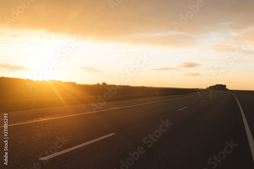 Asphalt road at sunset