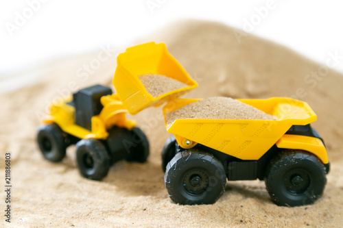 Construction concept - toy model machinery on sald