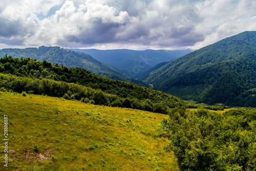 The mountain ridge is covered with fires under the thick clouds in the Carpathians © adamchuk_leo