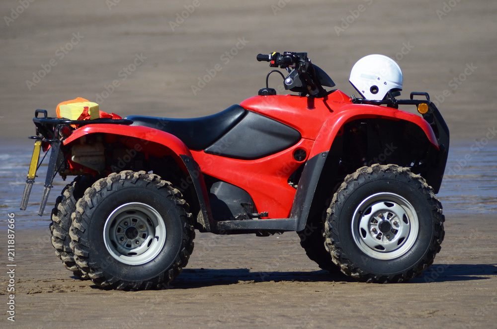 Red quad on the beach