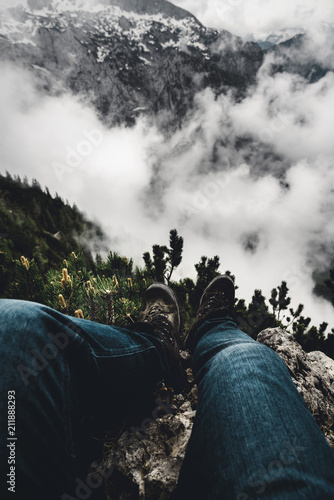 Mann sitzt auf einem Fels und blickt ins Tal vom Kehlsteinhaus / Eagels Nest photo