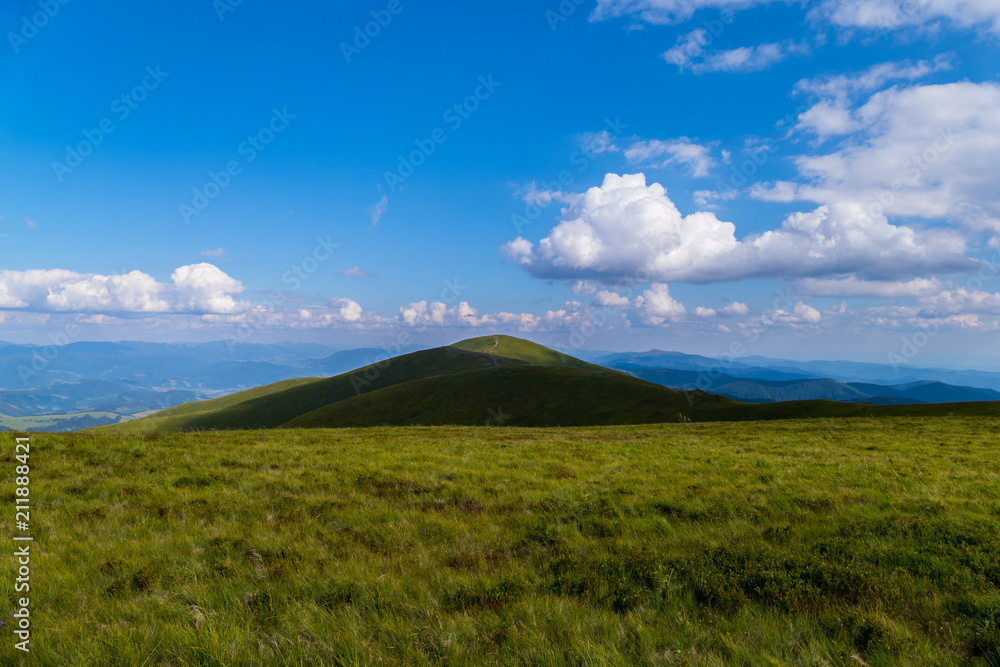 trampled path through the top of the mountain against the background of sky blue in the Carpathians