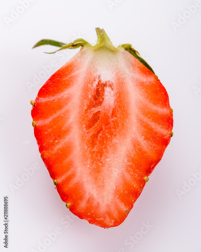 Juicy fresh strawberry on a white acrylic background