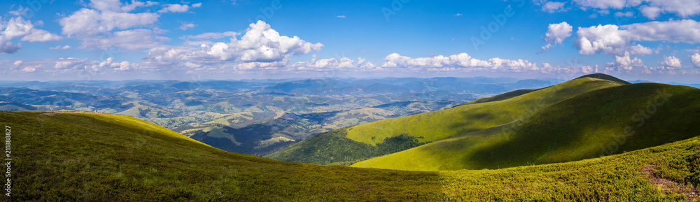 panorama of mountain peaks and forest plains