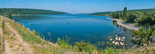 A beautiful panorama of the lake with a clear blue water located in a mountainous area.
