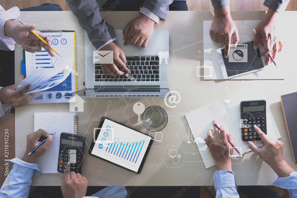 Fototapeta ONLINE ADVERTISING Business team hands at work with financial reports and a lapt