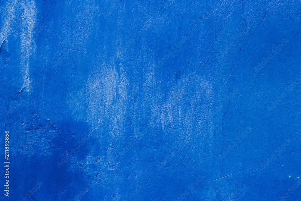 The texture of the blue wall with scratches and cracks