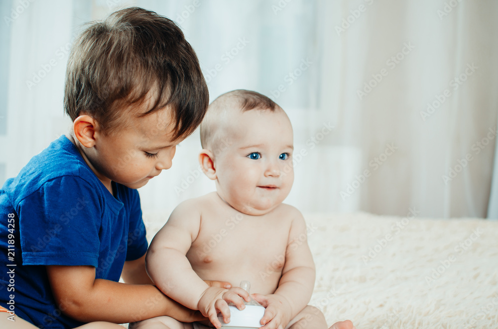 brother communicates and plays with her younger sister six months old brother communicates and plays with her younger sister six months old