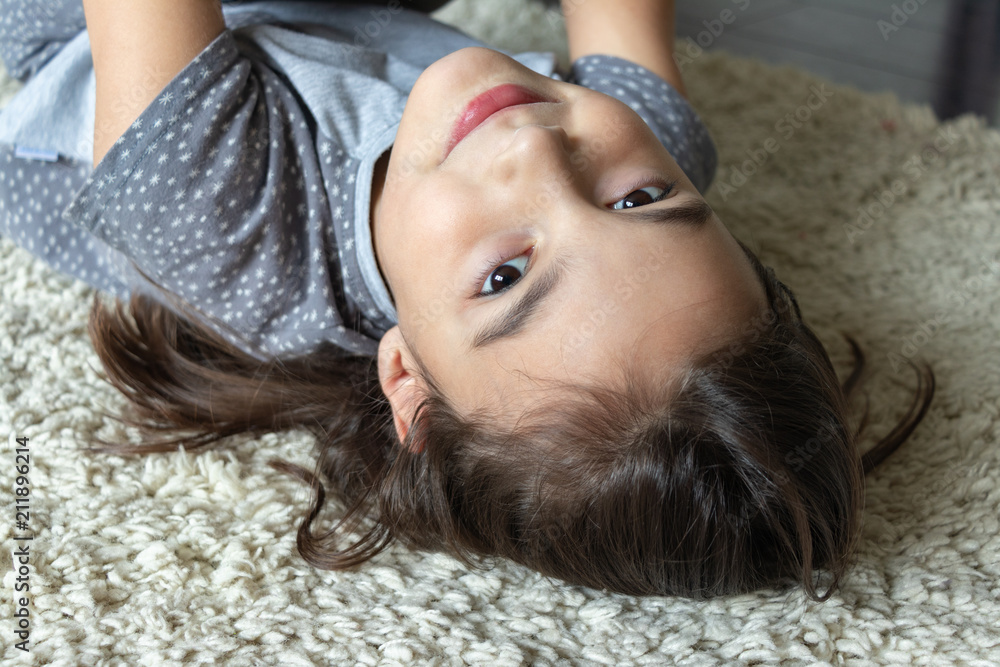 beautiful girl lies on a fluffy carpet beautiful girl lies on a fluffy carpet