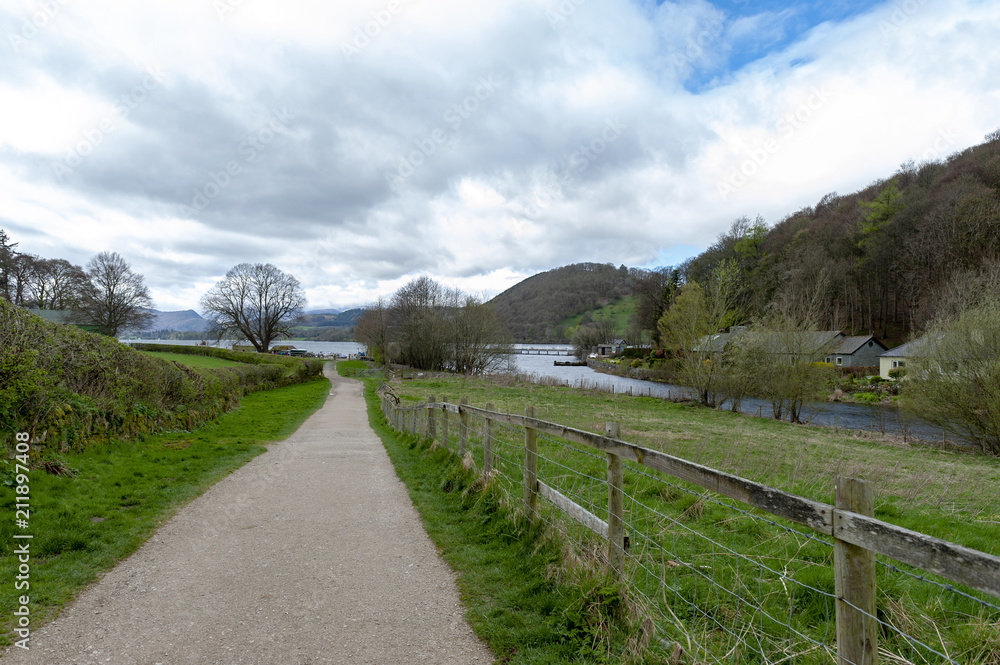 Walkway from Pooley Bridge village to the scenic lakeside of Ullswater in Lake District National Park, England, UK
