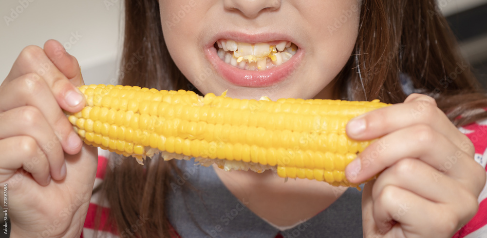 Beautiful girl gnaws / bites corn Beautiful girl gnaws / bites corn