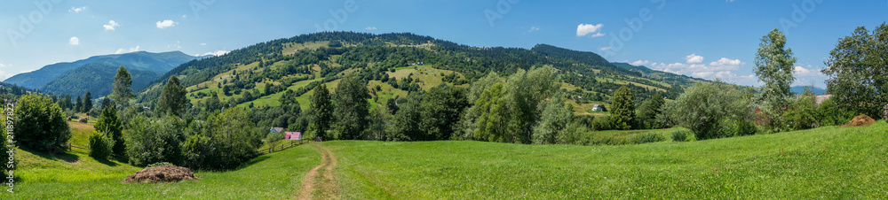 panorama to the path leading to houses and mountains