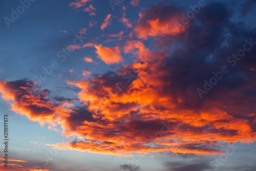 Beautiful bright colorful sky. Picture taken at sunset. Red-orange background with nice paints. Rare sunrise. Natural composition