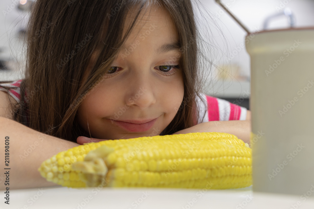 beautiful girl smiling looking at corn beautiful girl smiling looking at corn