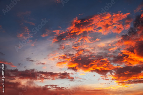 Beautiful bright colorful sky. Picture taken at sunset. Red-orange background with nice paints. Rare sunrise. Natural composition