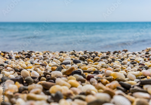 Sunny beach on the sea with sand and pebbles