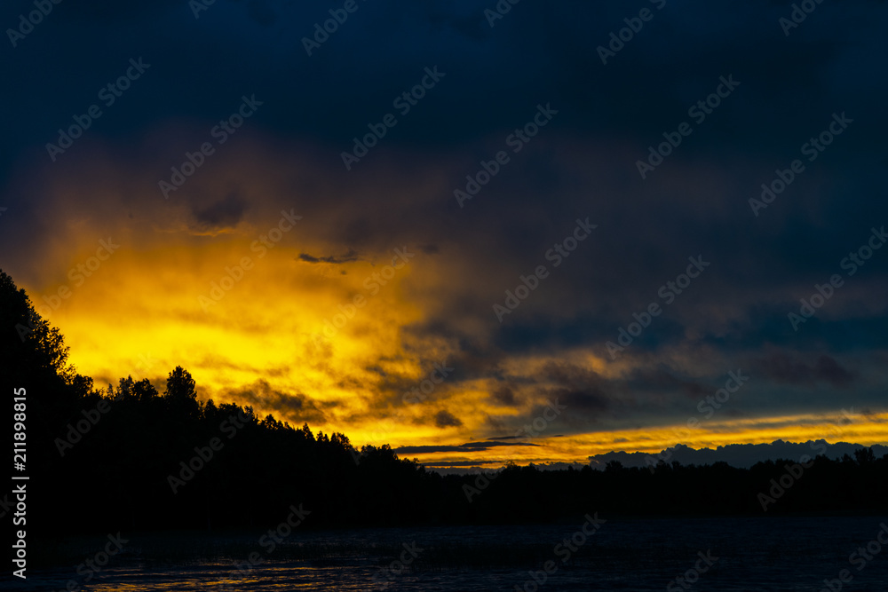 Obraz premium Sunset sky background. Dramatic gold sunset sky with evening sky clouds over the sea. Stunning sky clouds in the sunset. Sky landscape. Panoramic sky view.