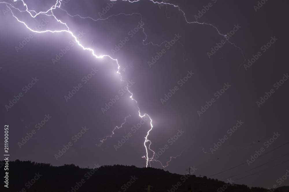 Thunderbolt falling on a power line of a village Thunderbolt falling on a power line of a village