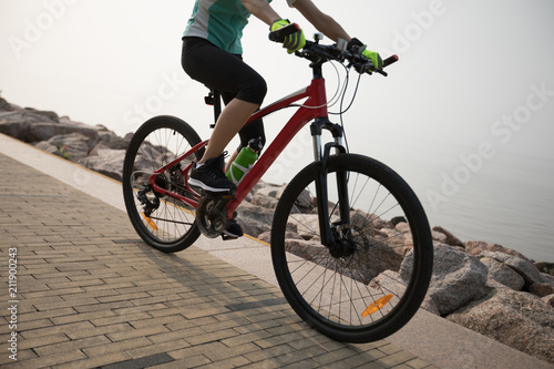 cyclist riding mountain bike on the coast trail © lzf