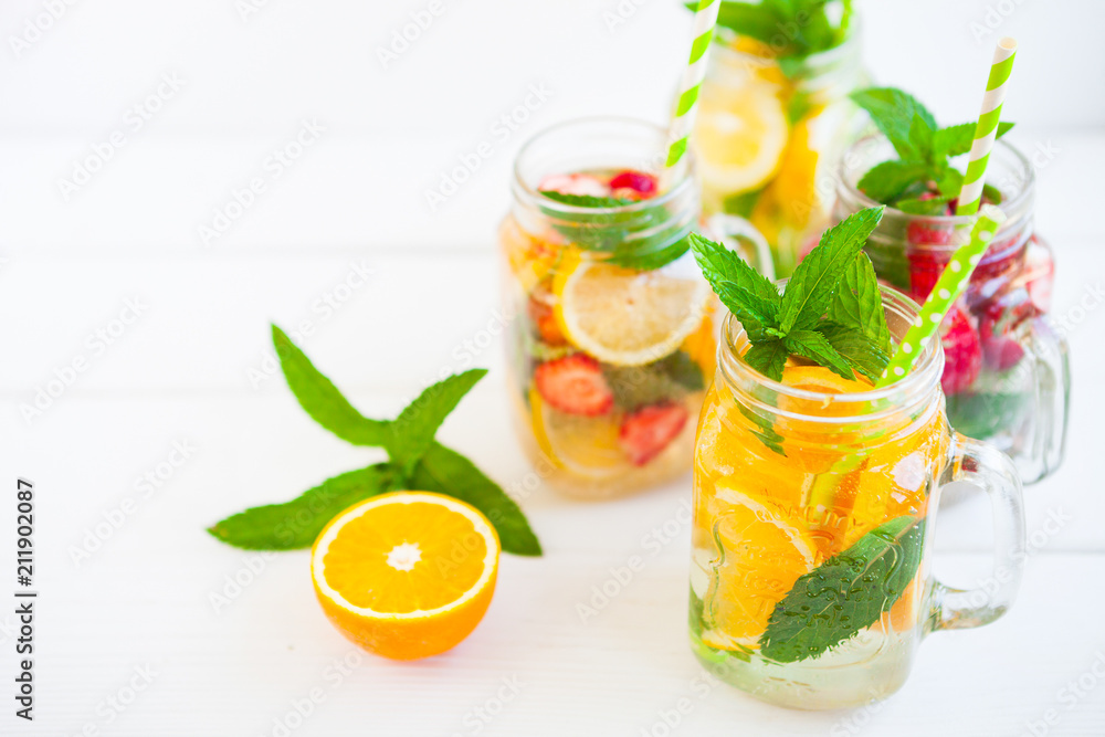 Homemade iced Fresh lemonade with mint, summer fruits and berries in a mason jar. Copy space background. Homemade iced Fresh lemonade with mint, summer fruits and berries in a mason jar. Copy space background.