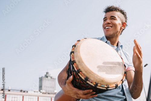 Hipster african american street drummer performing outdoors