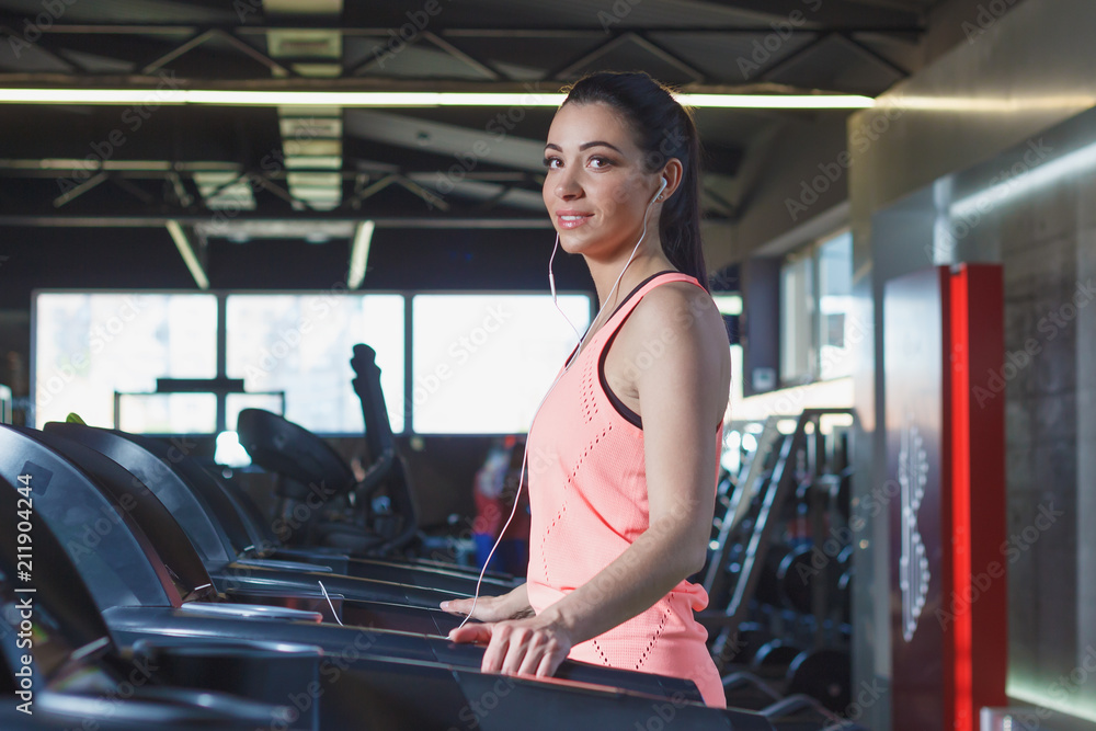 Sporty young woman makes sport exercises in the gym Sporty young woman makes sport exercises in the gym