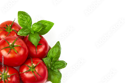 Fresh juicy tomatoes with basil leaf, isolated on white background. Close-up.