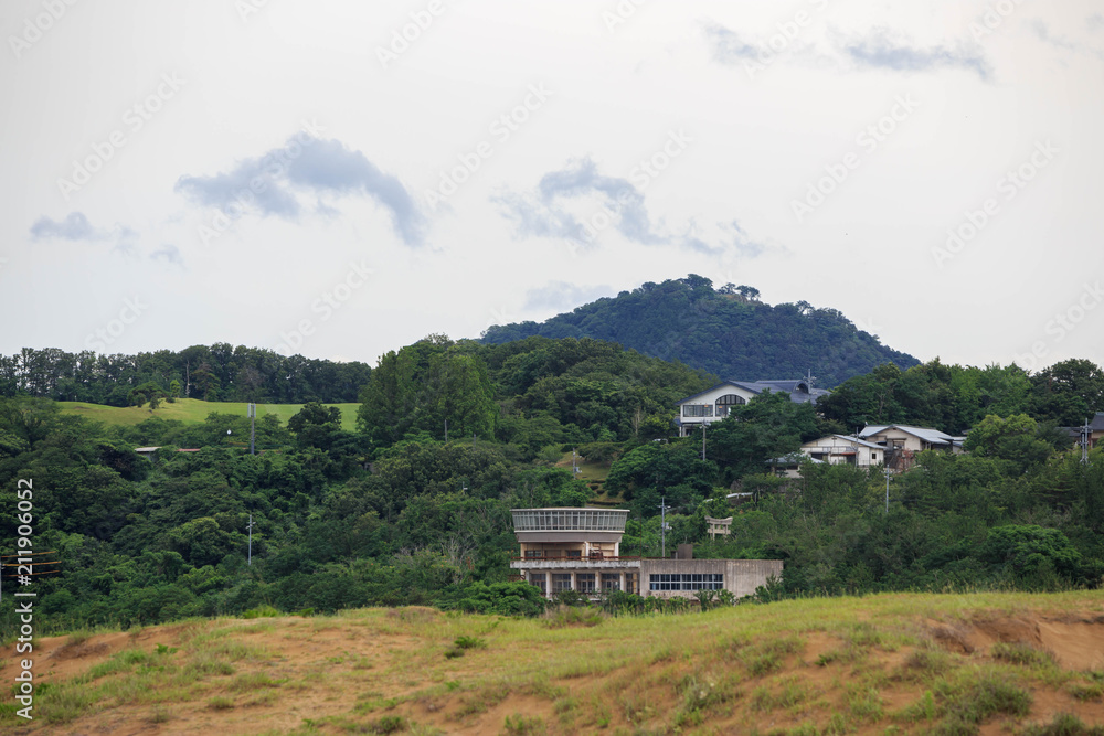 Old abandoned resort on the edge of Tottori Sand Dunes surrounded by green trees
