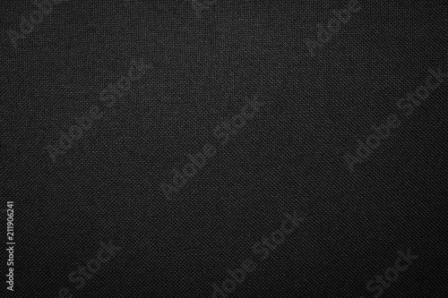 Black fabric texture background. Dark clothing material. photo