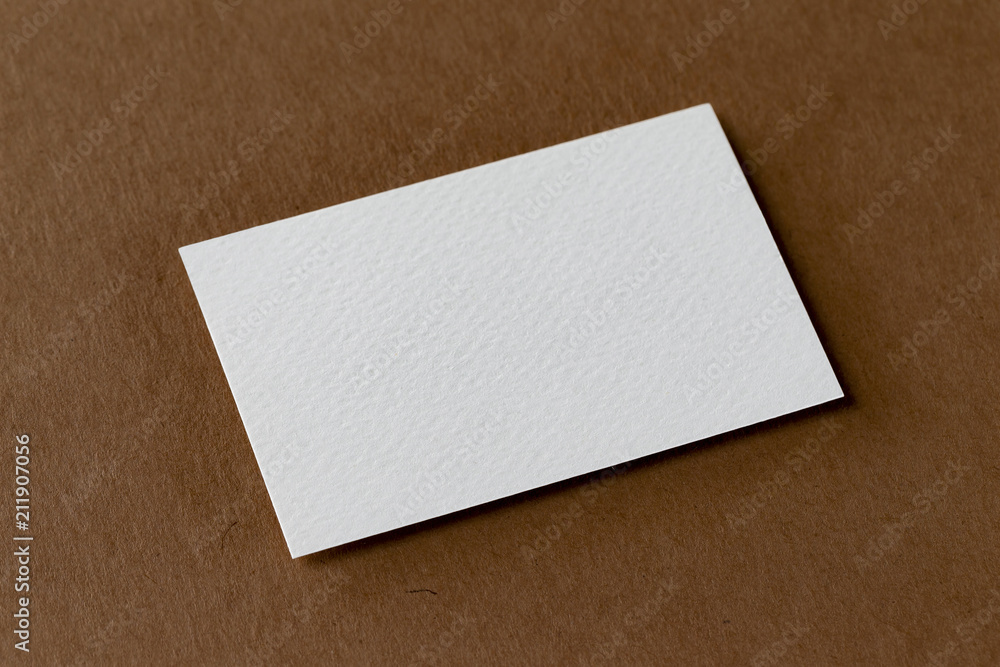 Mockup of single white business card at brown craft design paper background. Mockup of single white business card at brown craft design paper background.