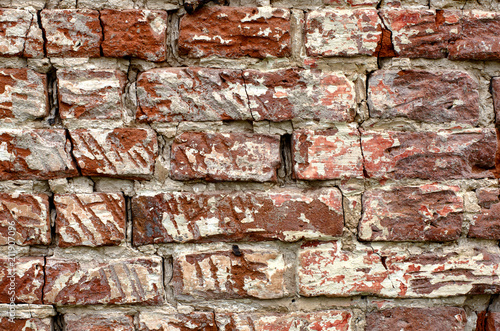 Rugged cracked vintage red brick wall with white patina close-up © Dmitriy Os Ivanov