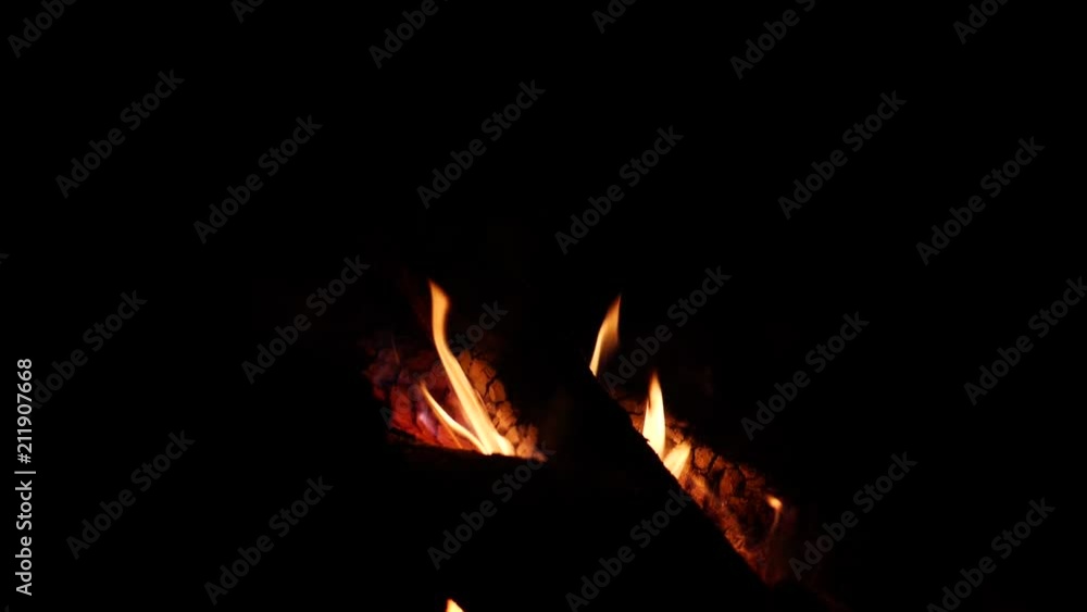 Burning firewoods - camping fire flame in slow motion at night Burning firewoods - camping fire flame in slow motion at night