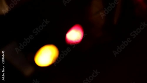 Night and festive lights. Defocused lights and glare. Abstract holiday decorations. Festive tinsel, confetti, balloons and light music