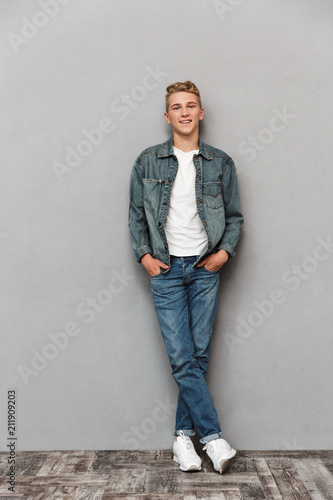 Full length portrait of a smiling casual teenage boy