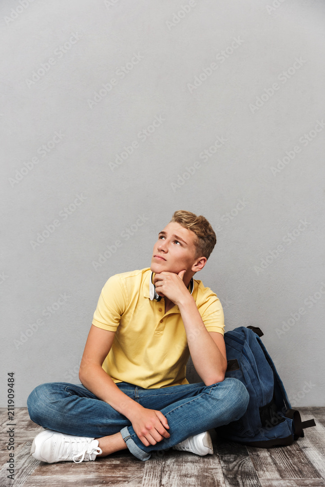 Portrait of a pensive casual teenage boy with backpack Portrait of a pensive casual teenage boy with backpack