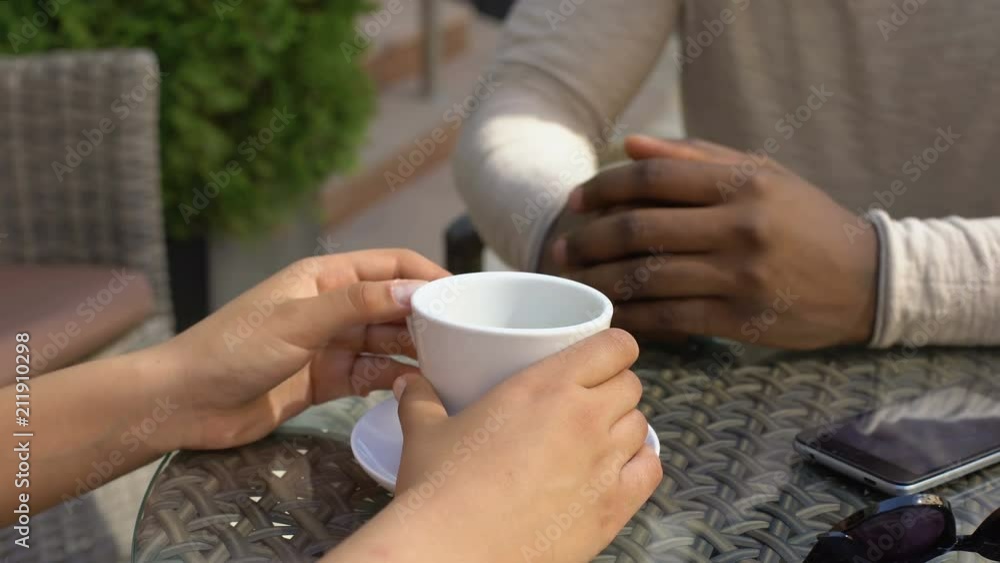 African man stroking girlfriend hands, romantic date in cafe, love expression African man stroking girlfriend hands, romantic date in cafe, love expression