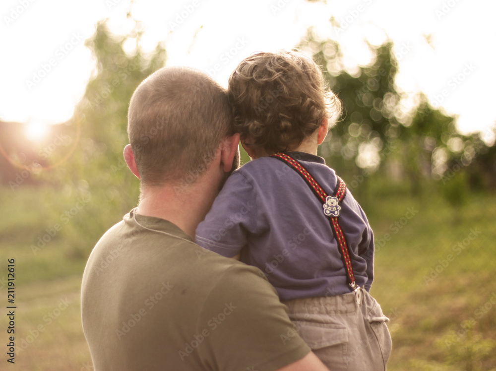 Fototapeta premium son in the hands of his father