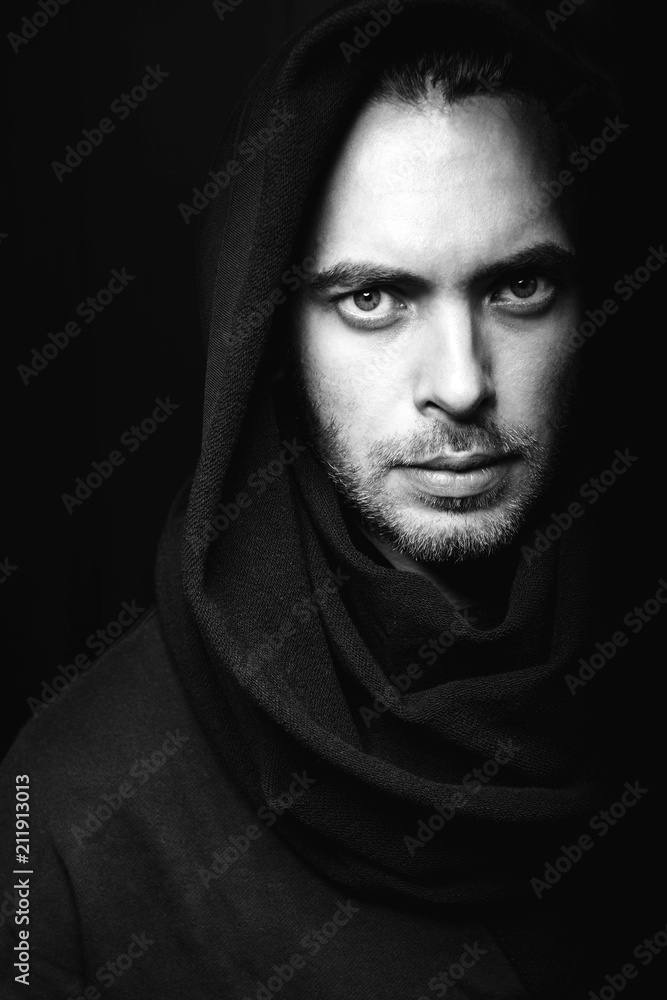Closeup portrait of caucasian man in a black cloak