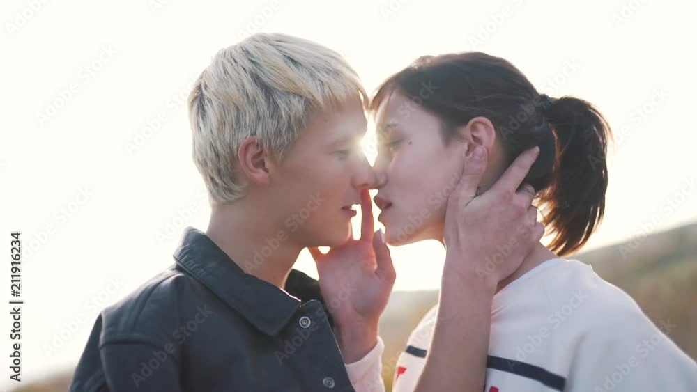 the couple passionately kisses in the sunlight. the couple passionately kisses in the sunlight.