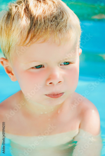 Portrait of baby boy enjoying swimming in inflatable pool © sponge_Po