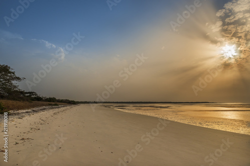 View of a beautiful deserted beach in the island of Orango at sunset  in Guinea Bissau. Orango is part of the Bijagos Archipelago  Concept for travel in Africa and summer vacations