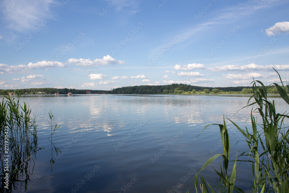 Fototapeta premium Summer clouds over the lake