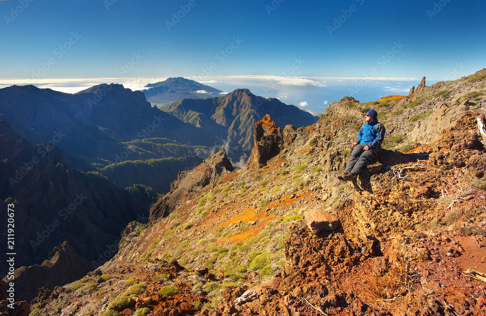 Resting man watching a landscape above the crater Caldera de Taburiente, Island of La Palma, Canary Islands, Spain